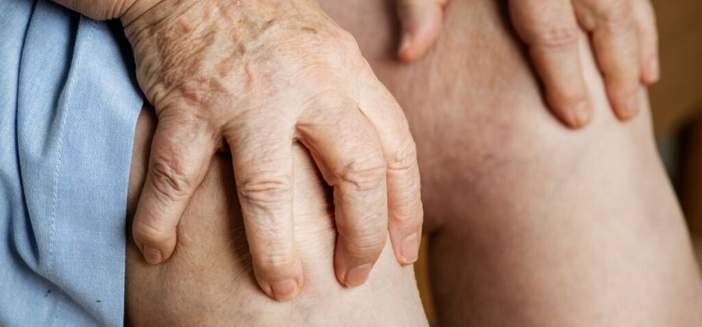 Elderly woman suffering knee pain