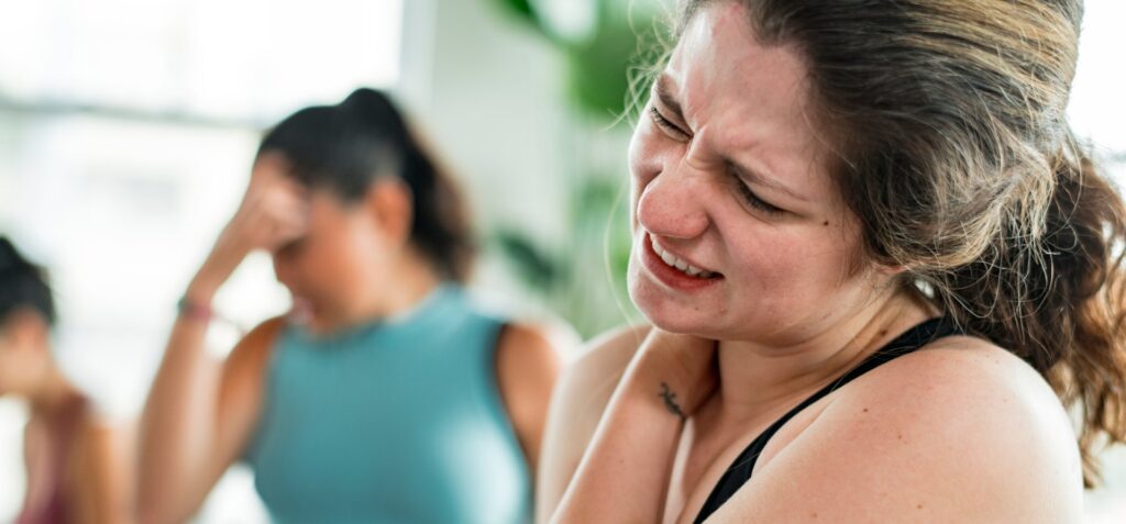 Woman having painful problems with her shoulder